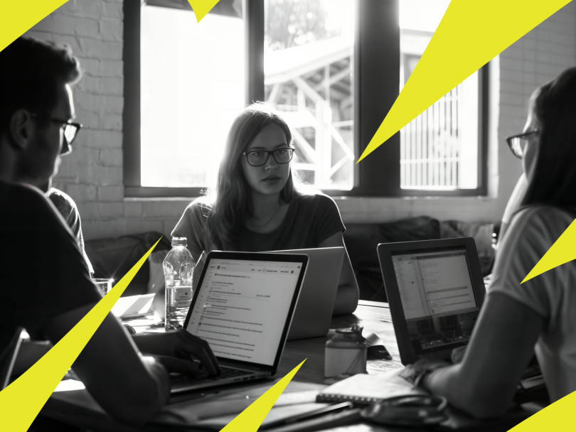Three Udemy team members work on a project together in the company’s office